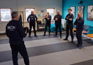 some of the training team in circle in the training room
