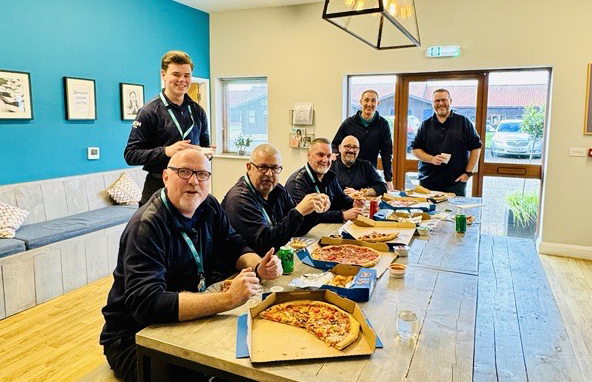 the training team eating pizza