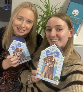 Le-Anne and Harriet holding up their chocolate Labradors! 