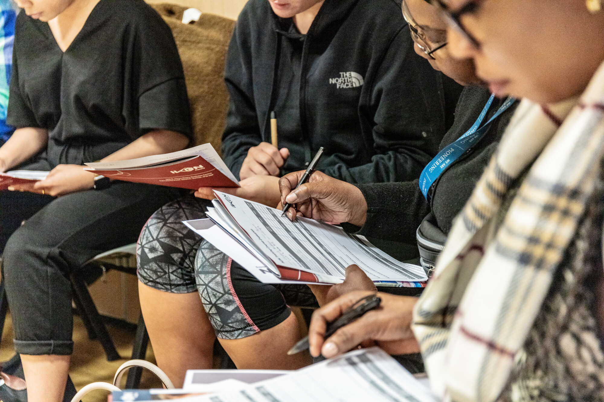 Learners writing on paper