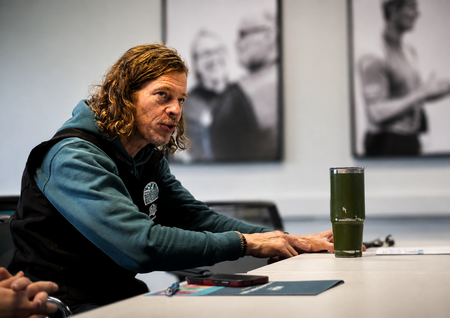 Learner with his phone by his side learning his organisational policies and asking questions to apply in the case of conflict at the IKON Training venue.